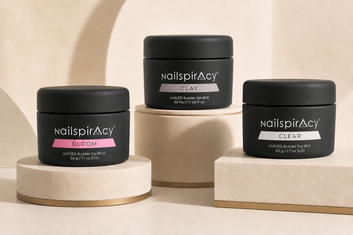 Nailspiracy BLOOM, CLAY and CLEAR Builder Gel jars displayed on ivory plinths